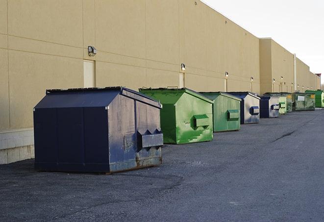 a compact construction dumpster being emptied by a waste disposal truck in Copperas Cove